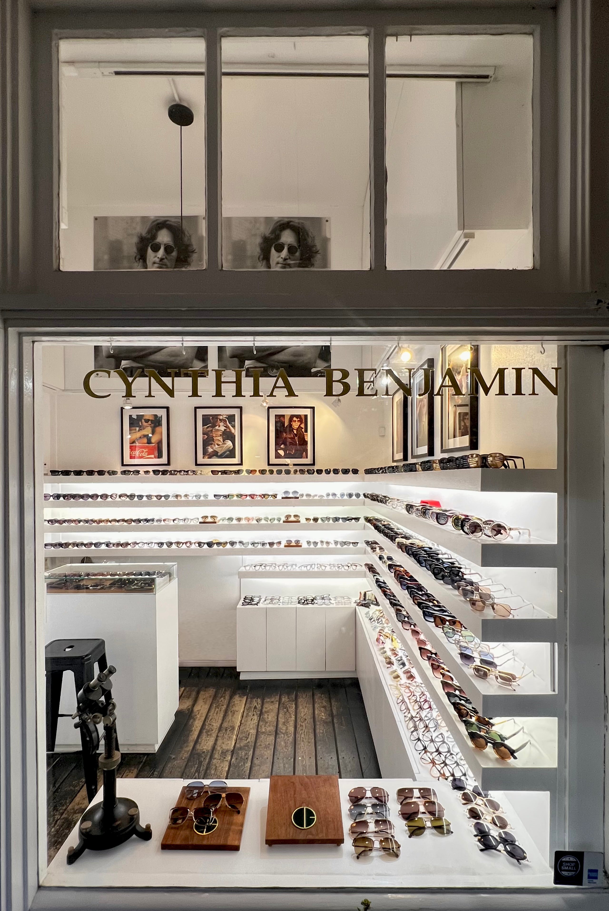 Earring display case with 'Cynthia Benjamin' branding in a jewelry store.